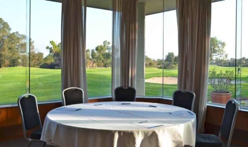 Cabernet room with a table and chairs overlooking the golf course